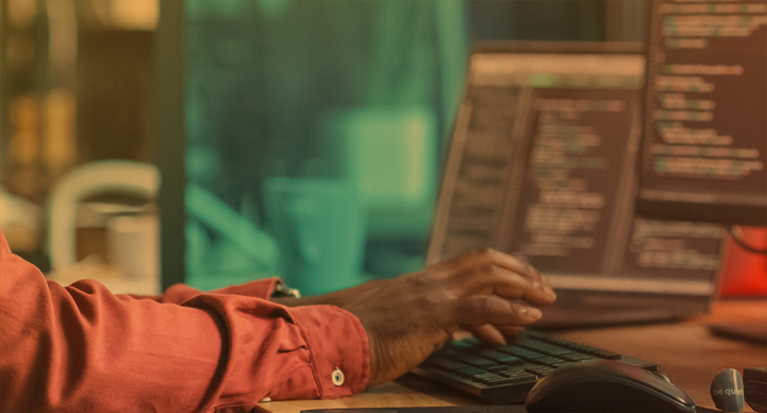 man's hands at a computer keyboard