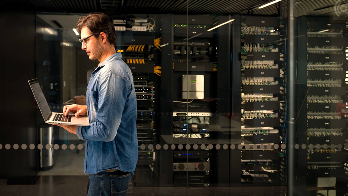 man with laptop in datacenter